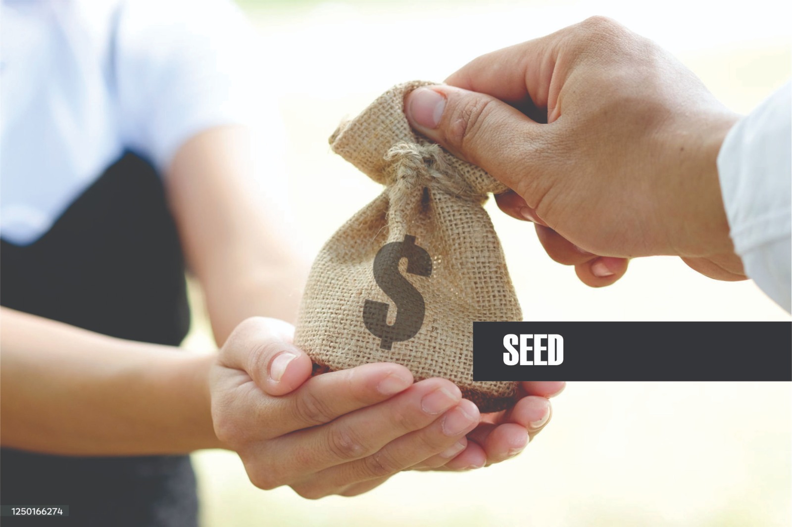 A bag of seed being handed from one person to another